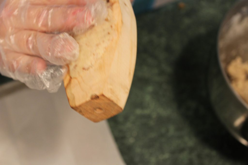 Covering the bottom with more pecan shortbread dough.